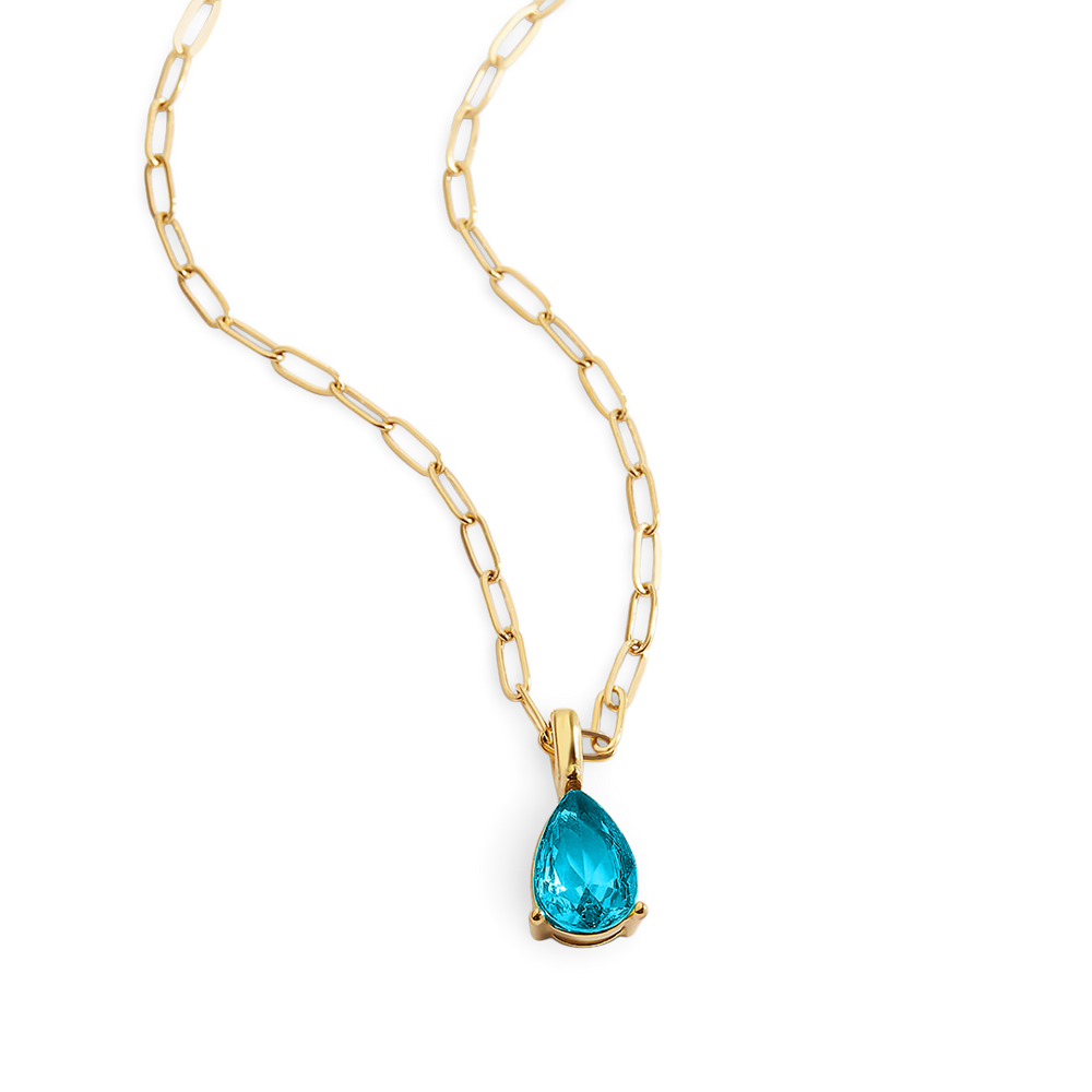 Gold necklace with a blue teardrop pendant on a white background