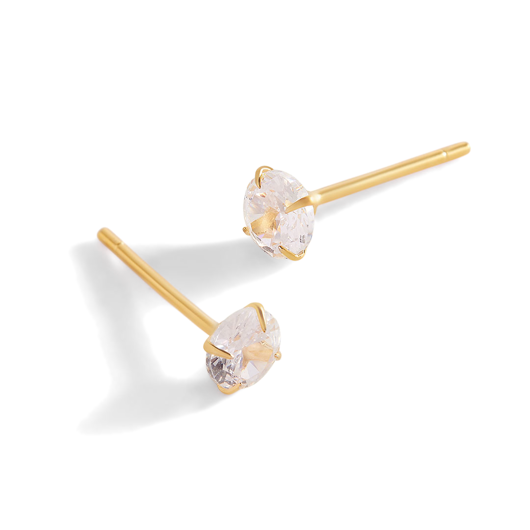 A pair of classic round solitaire stud earrings with gold vermeil casing and cubic zirconia stones.
