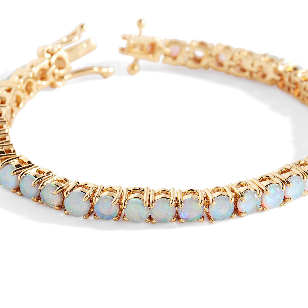 Gold bracelet with opal stones on a white background