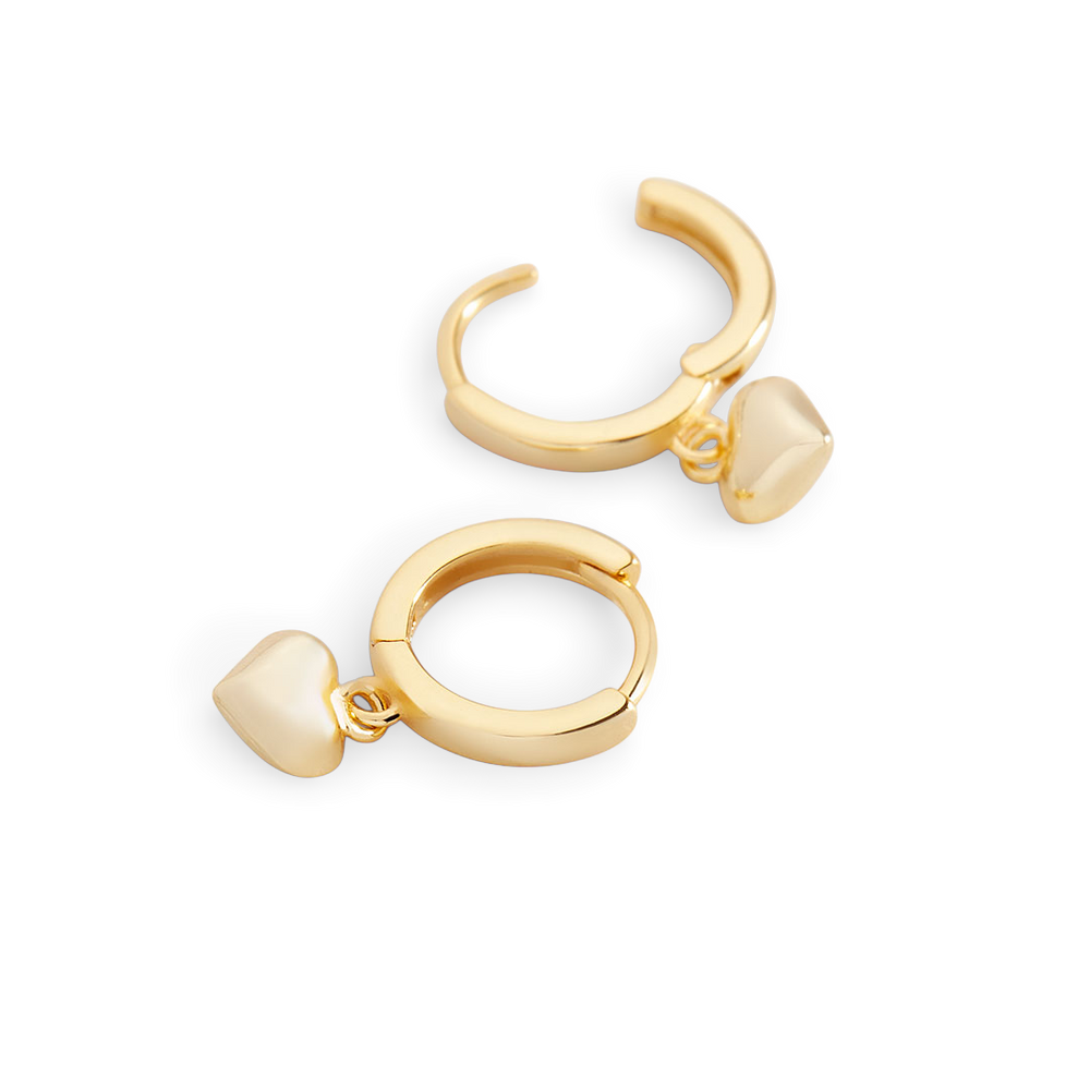 Gold hoop earrings with heart-shaped charms on a white background