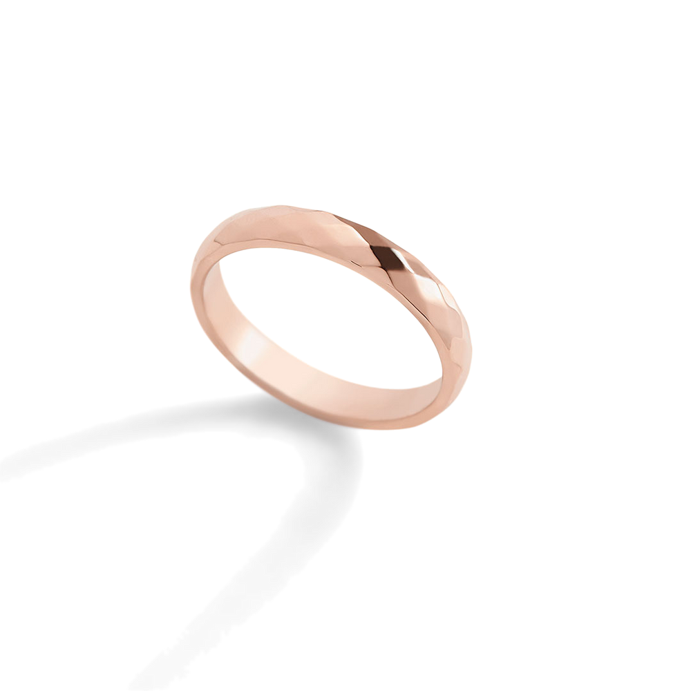 Rose gold ring on a light gray background