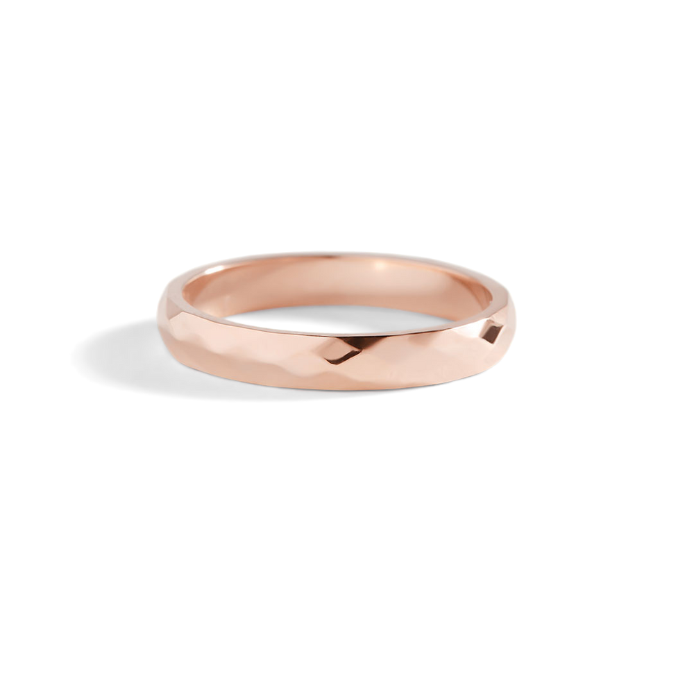 Rose gold ring on a light gray background