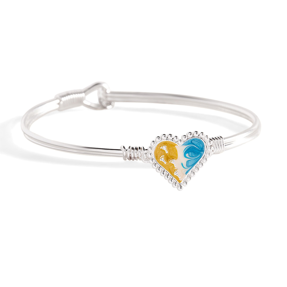 Silver bracelet with a heart-shaped charm featuring a yellow and blue design on a white background