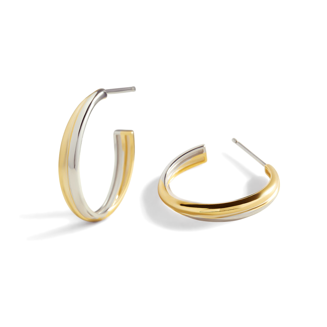 Gold and silver hoop earrings on a white background