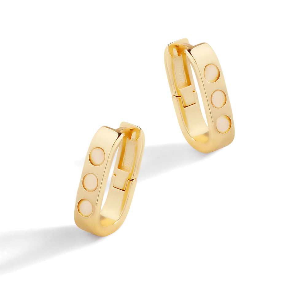 Gold hoop earrings with round cutouts on a light gray background