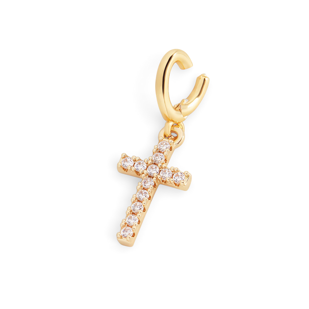 Gold cross-shaped earring with clear stones on a light gray background