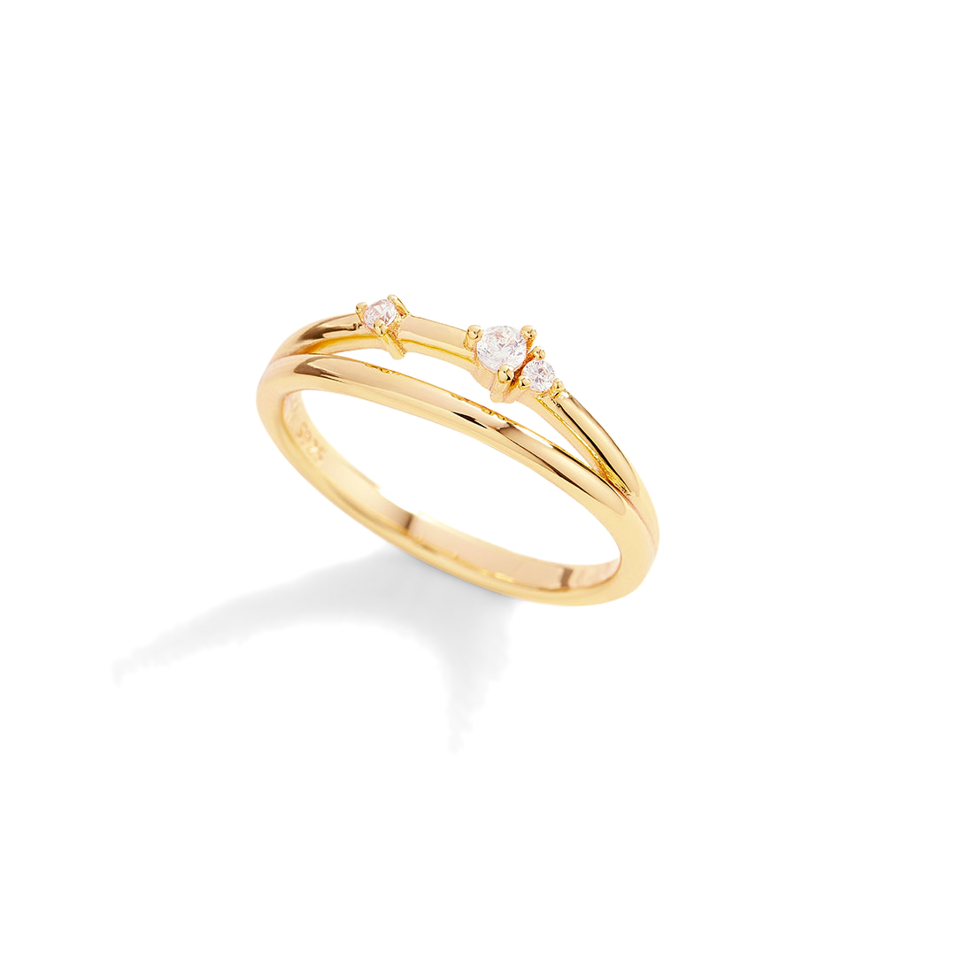 Gold ring with small diamonds on a light gray background