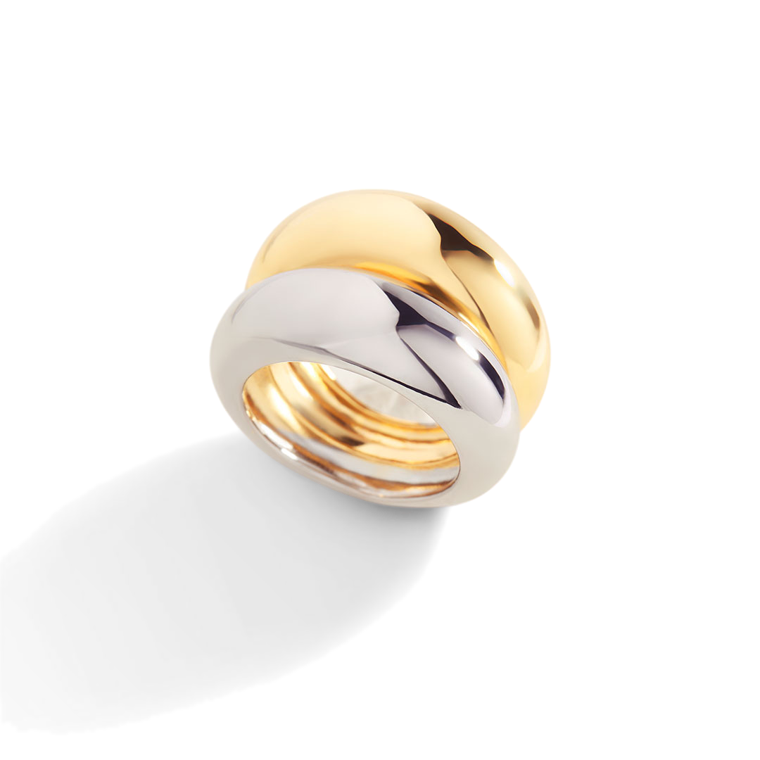Two-toned gold and silver ring on a light gray background