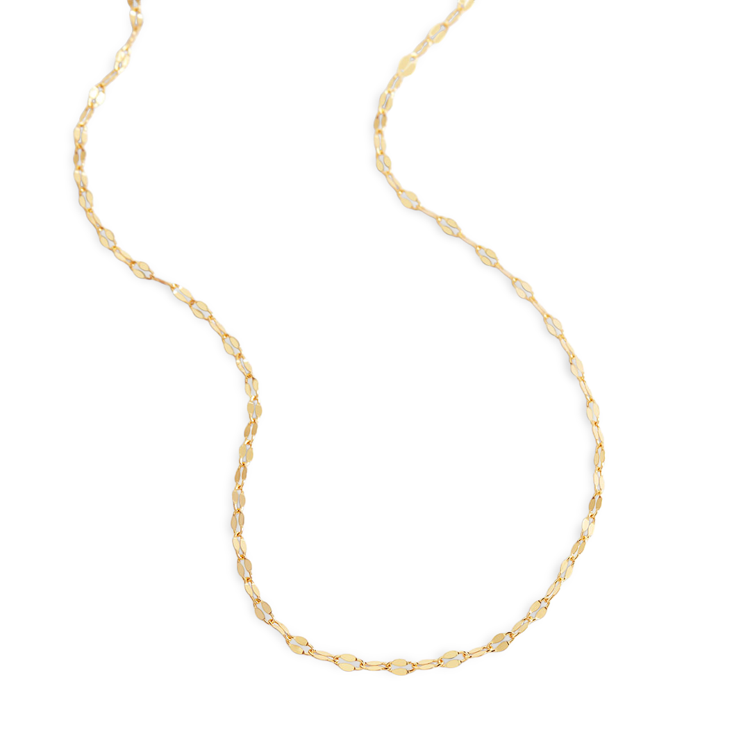 Gold chain necklace on a light gray background