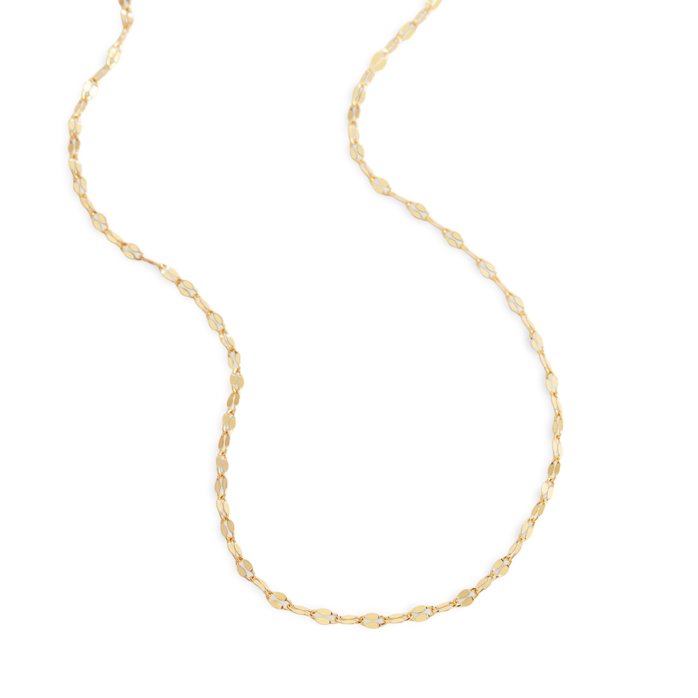 Gold chain necklace on a light gray background