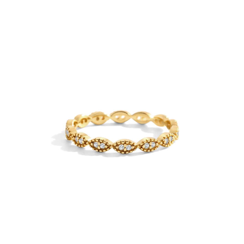 Gold ring with intricate design on a white background