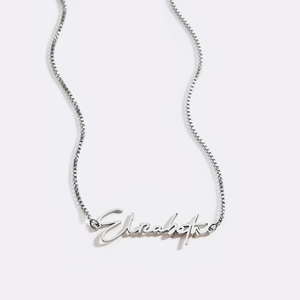 A gold name necklace with the name 'Elizabeth' written in cursive script on a black background.