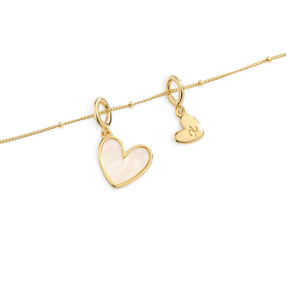 Gold heart-shaped pendants on a white background