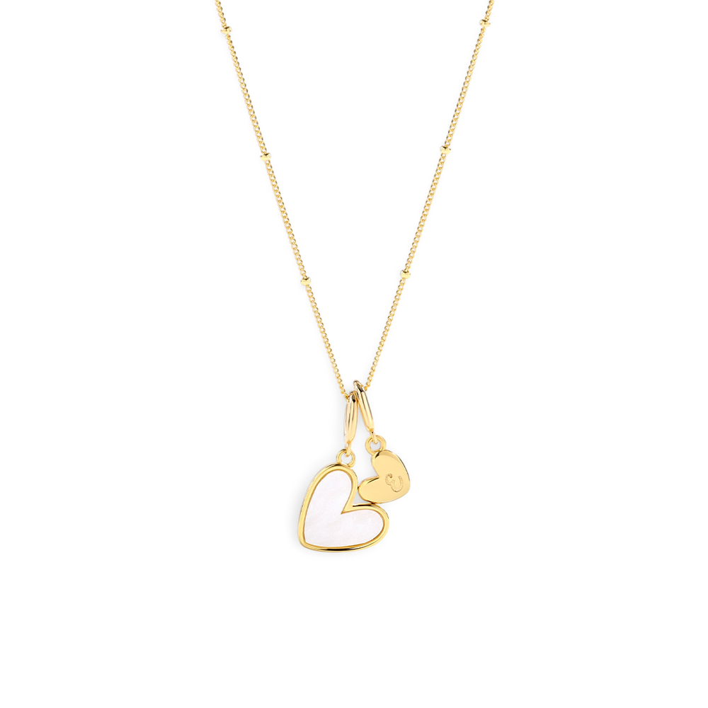 Gold heart-shaped pendant necklace on a light gray background