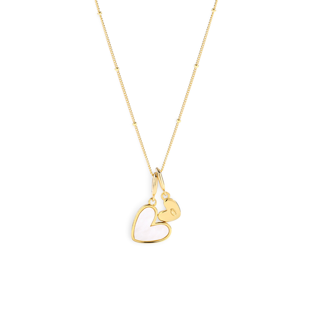 Gold heart-shaped pendant necklace on a light gray background