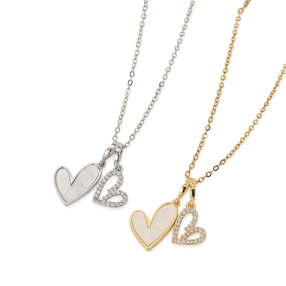 Two heart-shaped pendants on chains, one silver and one gold, on a white background.