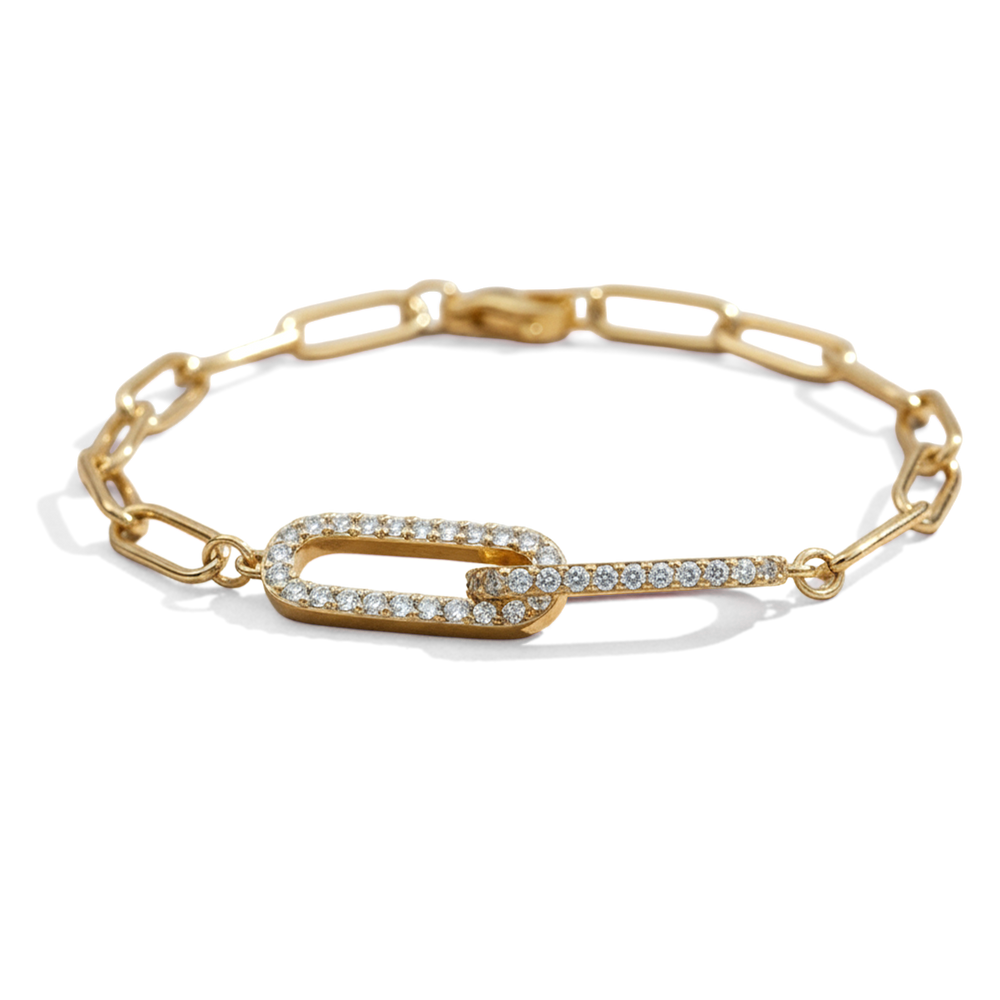 Gold bracelet with a clasp design on a light gray background