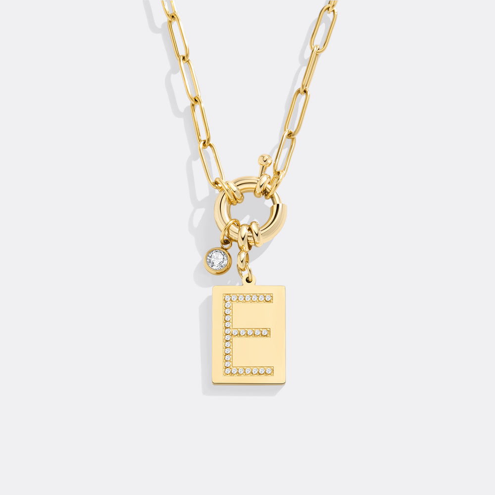 Gold necklace with letter 'E' pendant on a white background