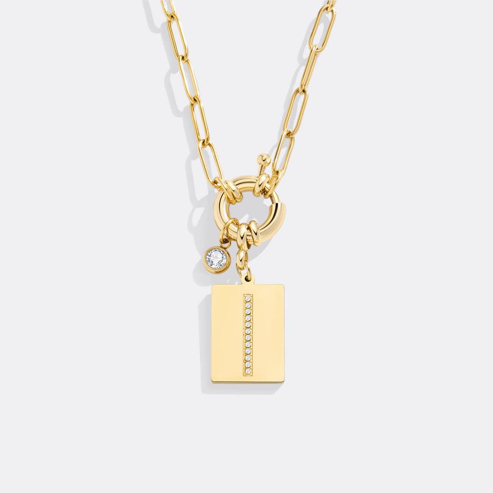 Gold necklace with charms on a white background