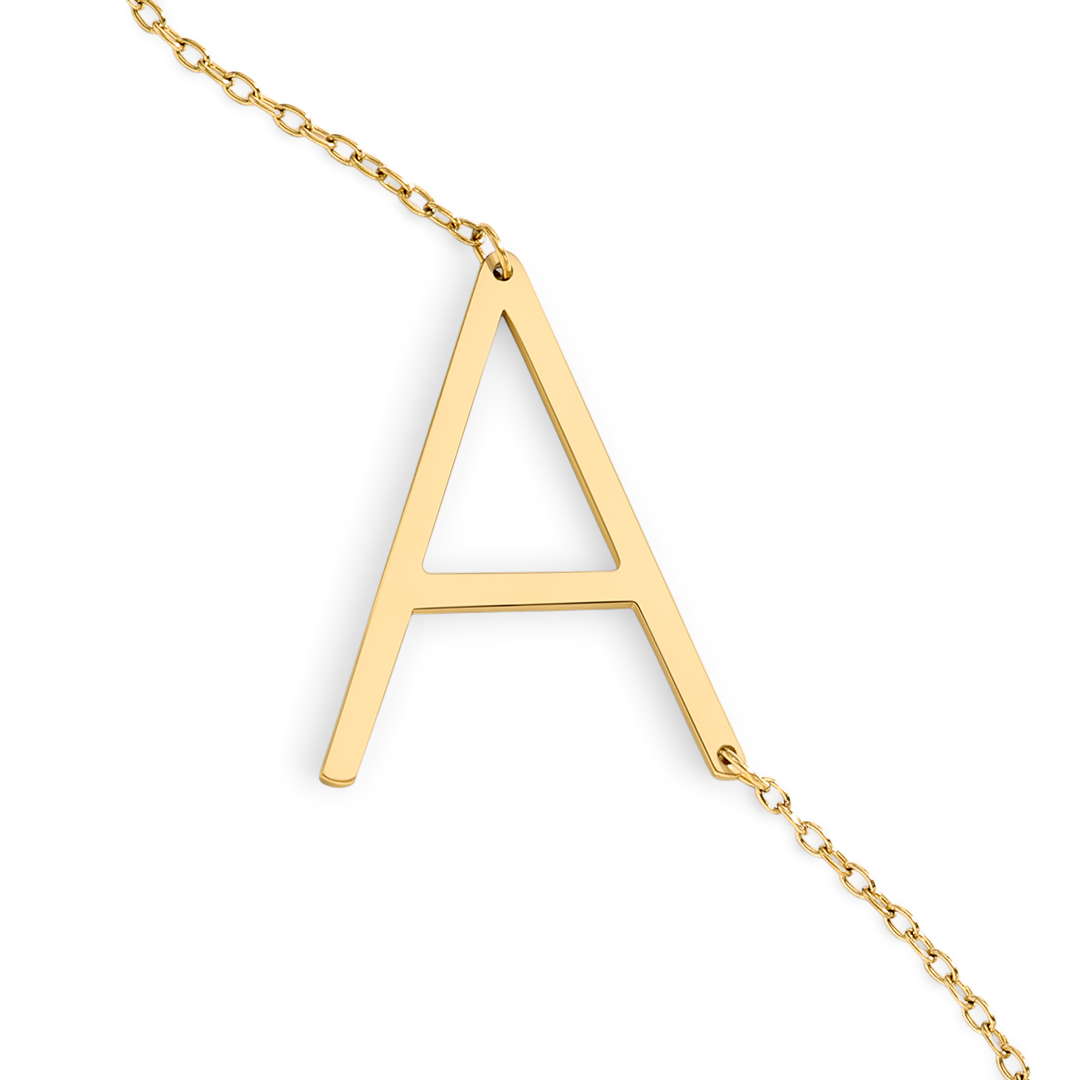 Gold necklace with a letter 'A' pendant on a light gray background