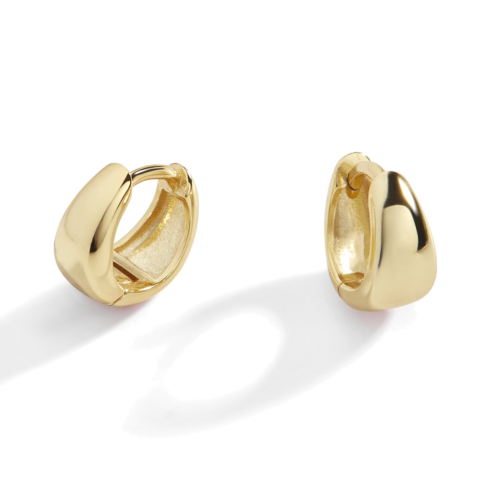A pair of gold huggie hoop earrings with a teardrop design on a black background.