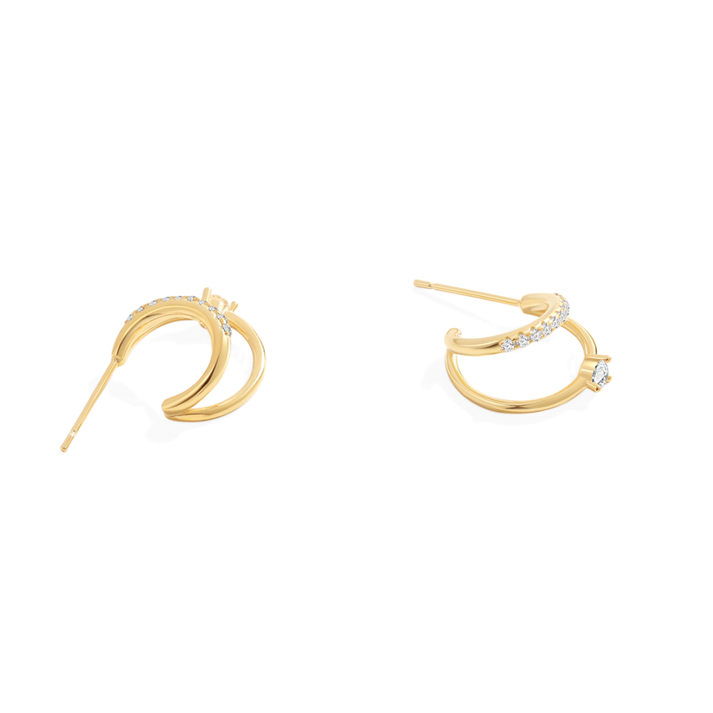 Gold hoop earrings with small diamonds on a light gray background