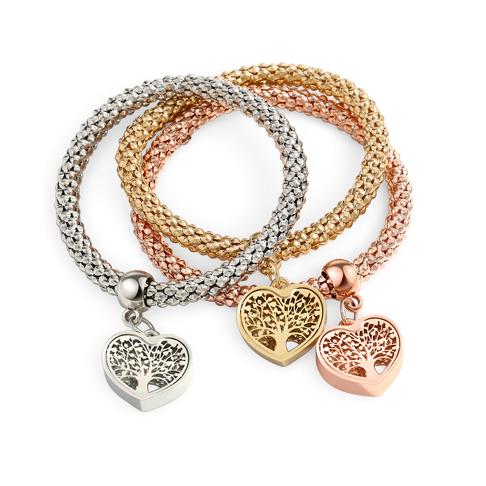 Three heart-shaped charm bracelets in silver, gold, and rose gold on a white background.