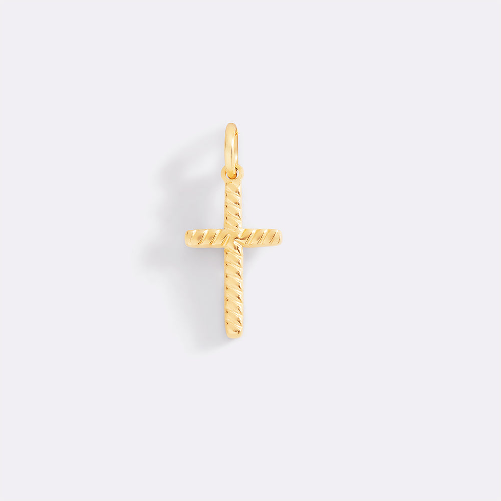 Gold cross pendant on a light gray background