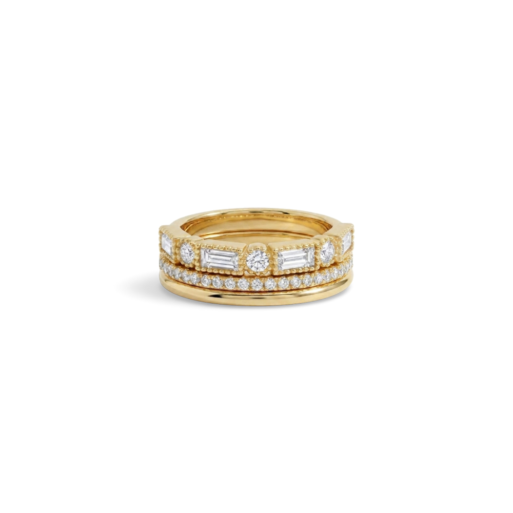 Vintage Ring Stack: three gold stacking rings, including a round and baguette CZ ring, shown together on a white background