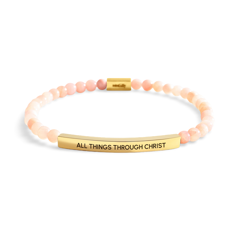 Bracelet with 'All Things Through Christ' engraving on a light gray background