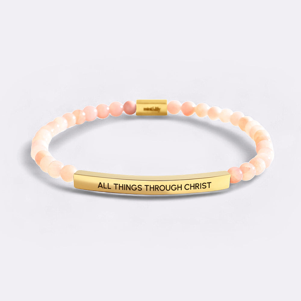Bracelet with 'All Things Through Christ' engraving on a light gray background