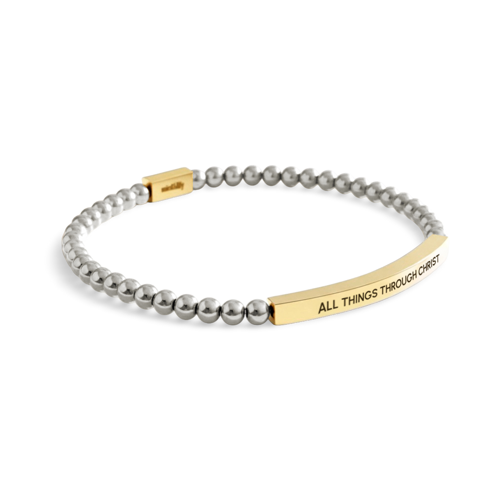 Bracelet with gray beads and gold tag on a white background