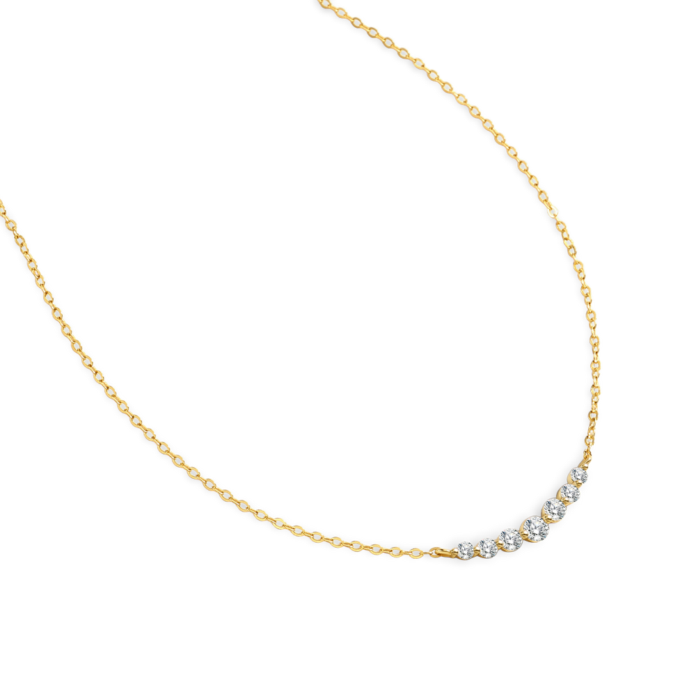 Gold necklace with small diamonds on a white background