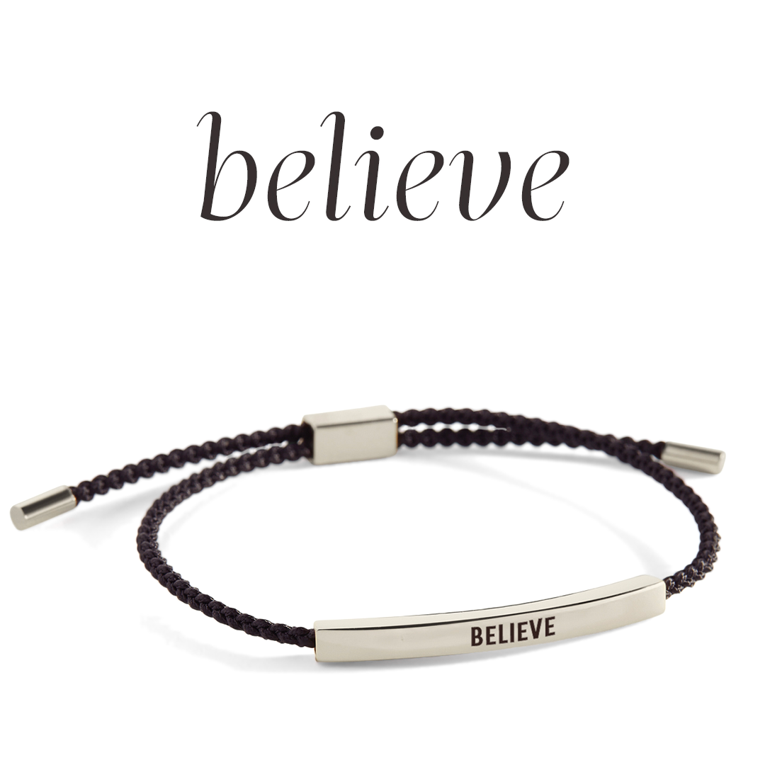 Bracelet with 'BELIEVE' engraving on a light background
