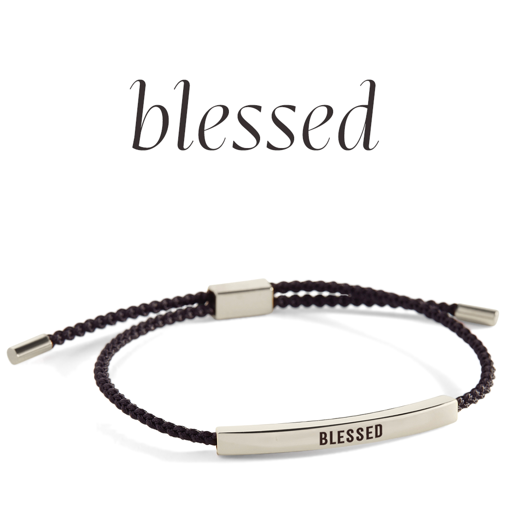 Bracelet with 'blessed' engraving on a light gray background