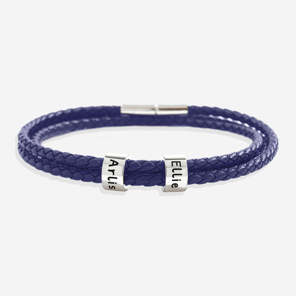 Blue braided bracelet with silver name tags on a white background