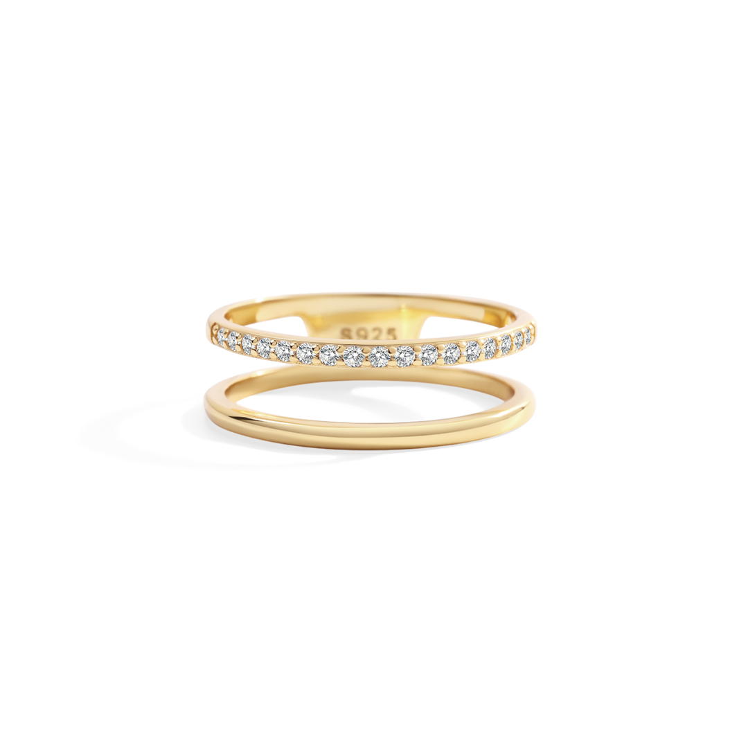 Gold ring with diamond accents on a white background
