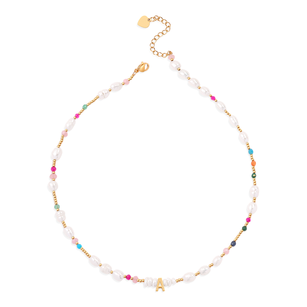 A gold-colored initial necklace with white pearl and multicolored gemstone embellishments, displayed against a black background.