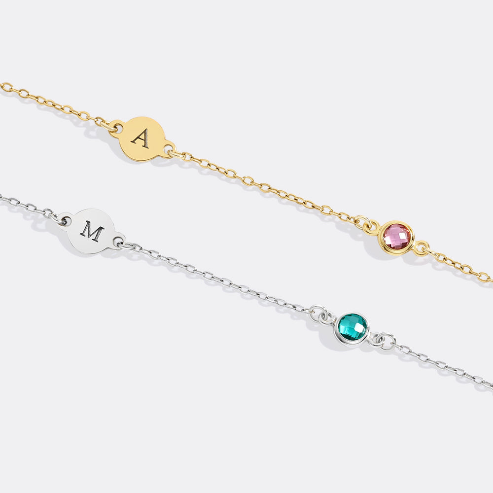 Two gold and silver bracelets with gemstones on a white background