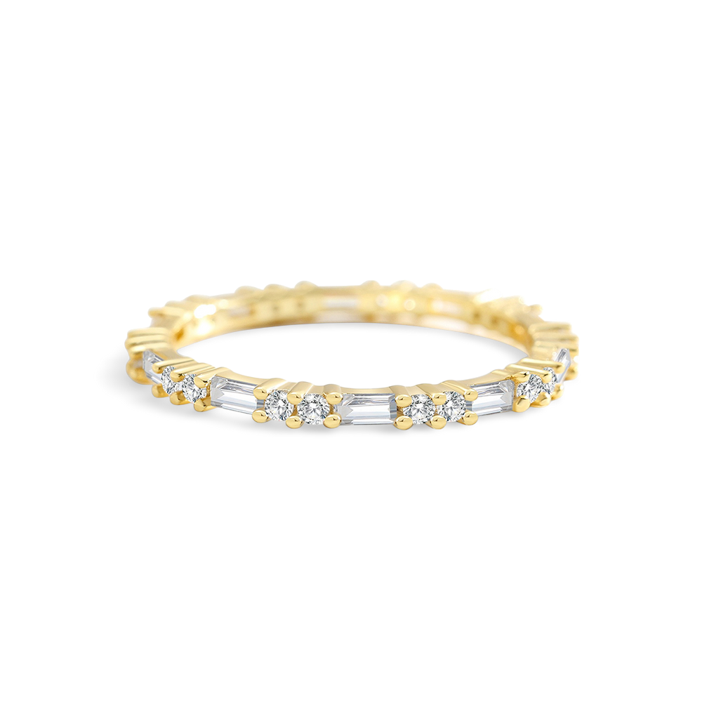 Gold ring with embedded diamonds on a light gray background