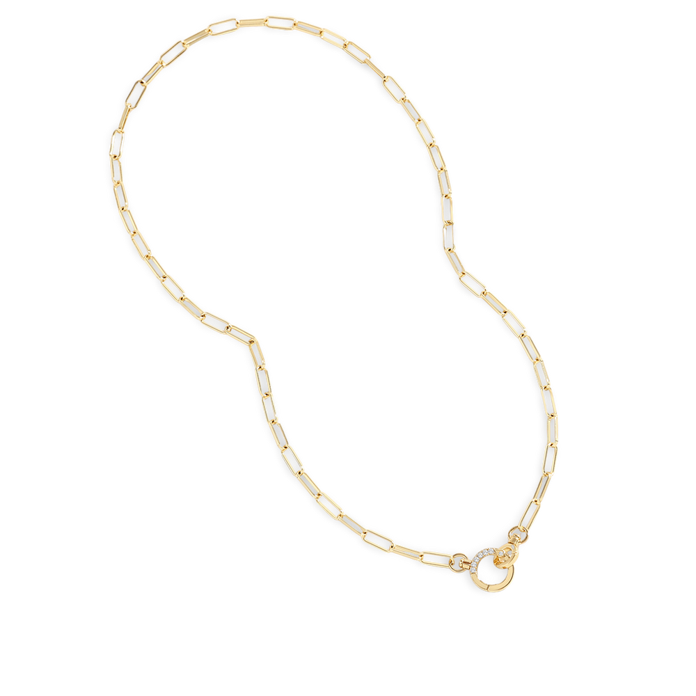 Gold chain necklace with white beads on a light gray background