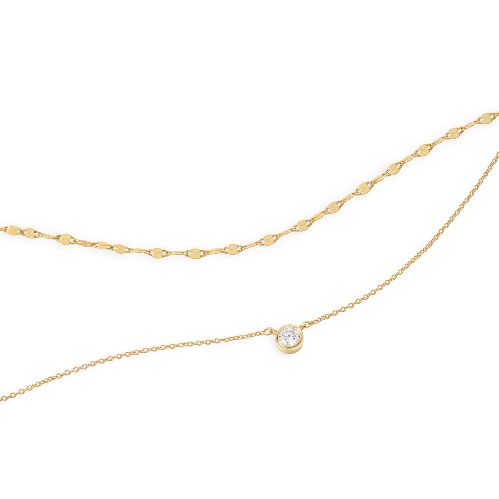 Gold chain necklace with a small pearl pendant on a white background