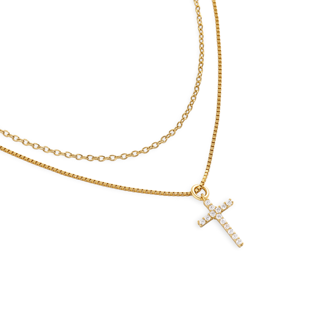 Gold necklace with a small cross pendant on a white background