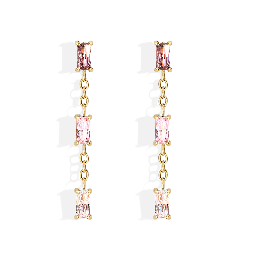 Gold earrings with pink gemstones on a light gray background