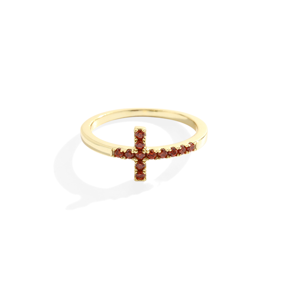 Gold ring with red gemstones on a white background