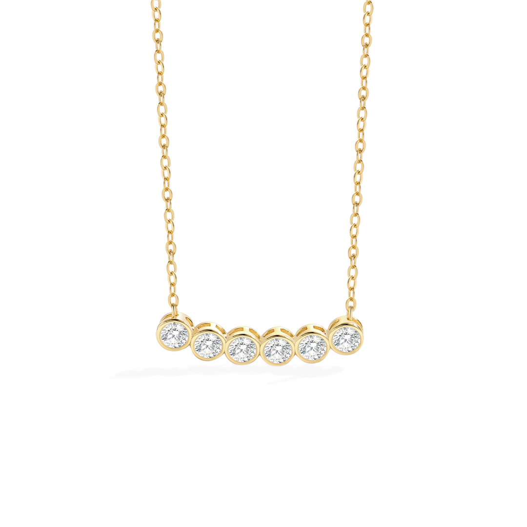 Gold necklace with five round diamonds on a white background
