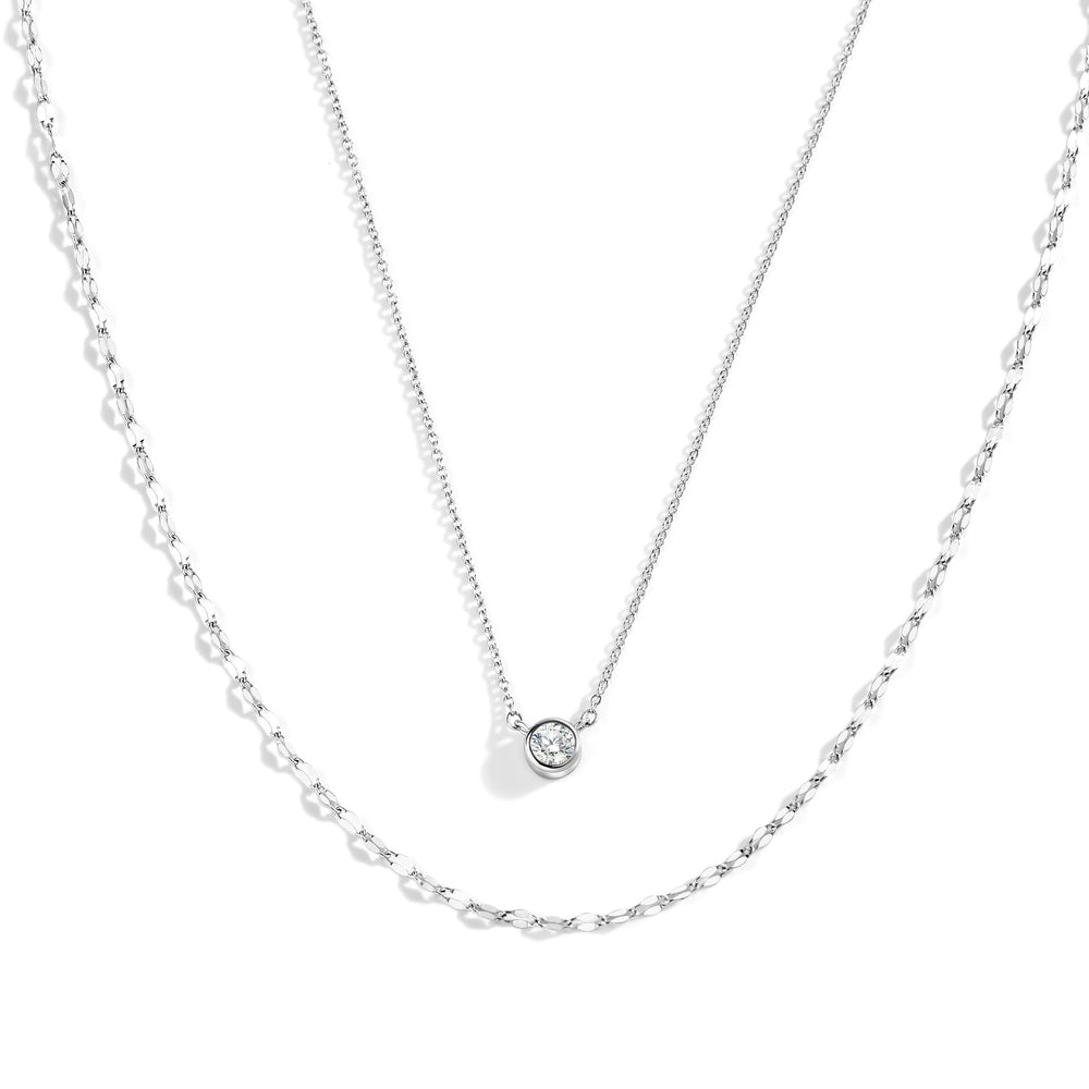 Silver necklace with a small round pendant on a white background