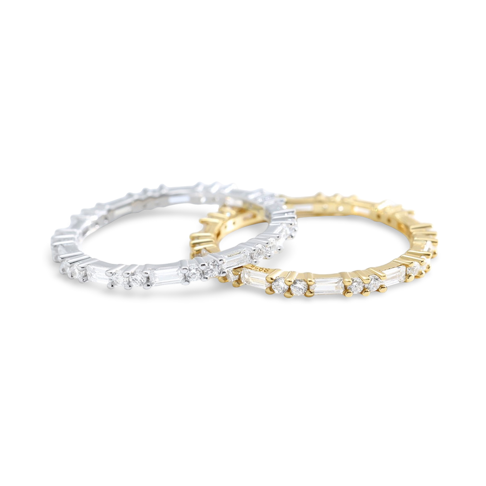 Two gold and silver rings with gemstones on a white background
