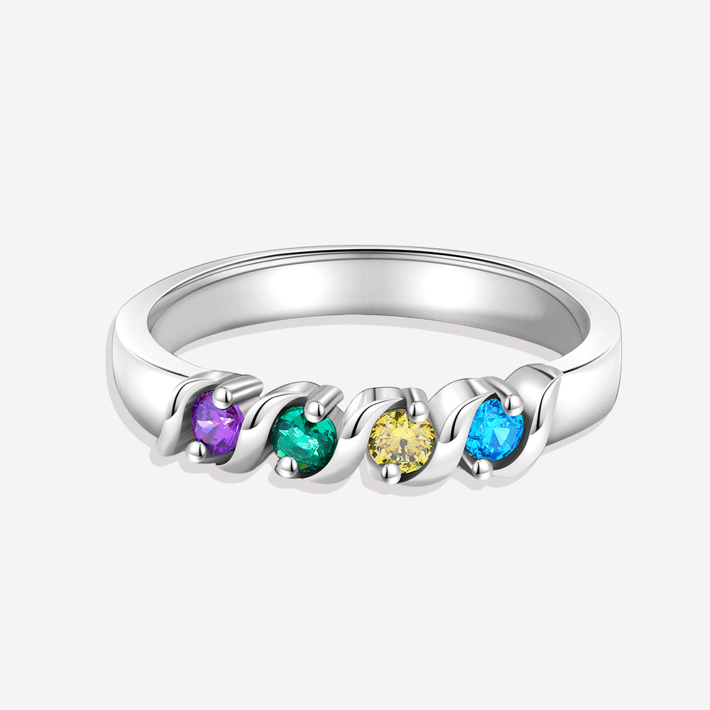 A gold-colored ring with a flowing wave design, featuring multicolored gemstones set along the band.