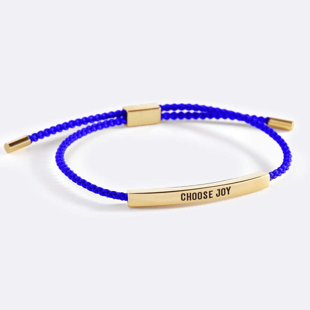 A bracelet with the text 'choose joy' printed on it, displayed on a white background.